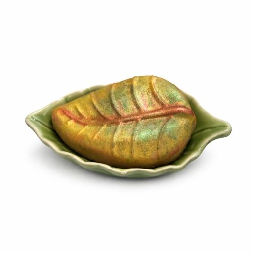 leaf shaped goat milk soap with matching green ceramic leaf dish on white background