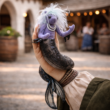 fantasy sea nymph wristlet puppet with purple body and flowing tail worn on hand against white background